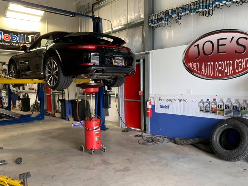 A car is being worked on in the garage.